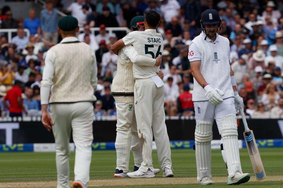 Australia's Mitchell Starc (centre right) celebrates with teammates after taking the final wicket