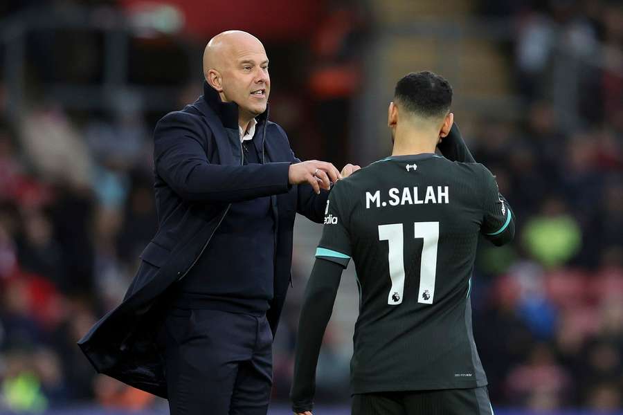 Slot speaks with Salah during the match