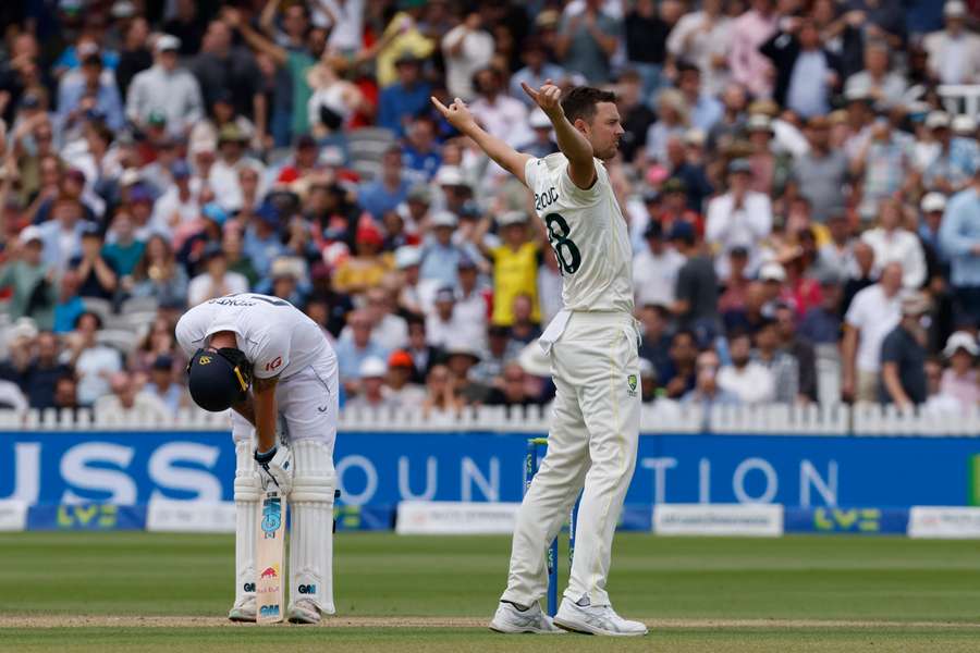 Australia's Josh Hazlewood (R) celebrates after taking the wicket of England's captain Ben Stokes (L) for 155 runs