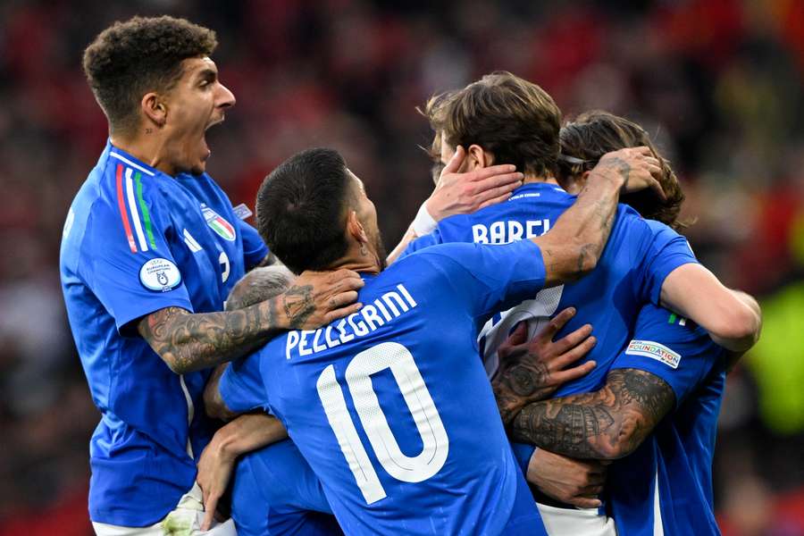 Italy players celebrate with goal scorer Nicolo Barella 