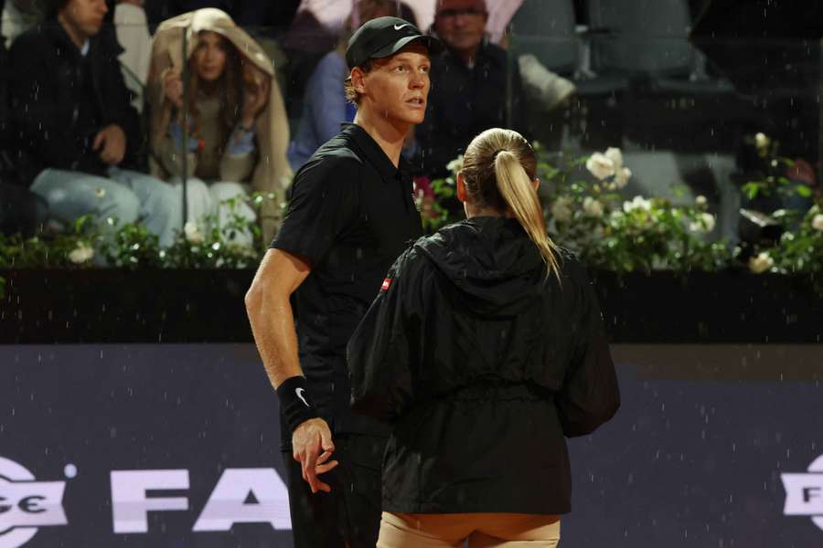 Jannik Sinner reacts as rain interrupts play during his semi final match against Daniil Medvedev