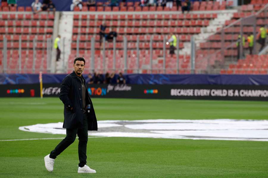 Girona coach Michel walks on the pitch before the match