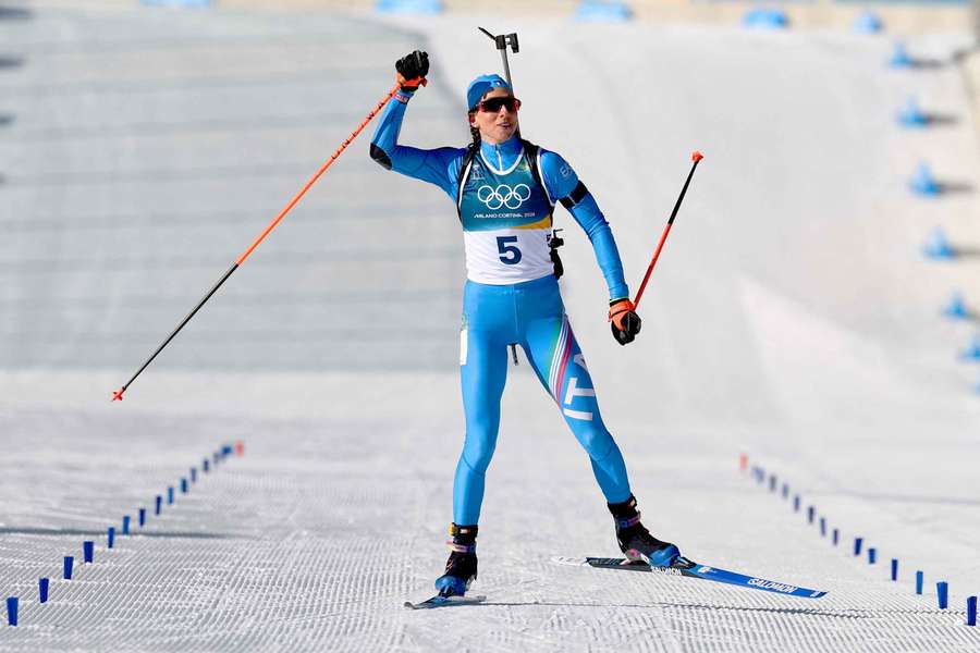Lisa Vittozzi of Italy celebrates as she crosses the finish line to win the gold medal
