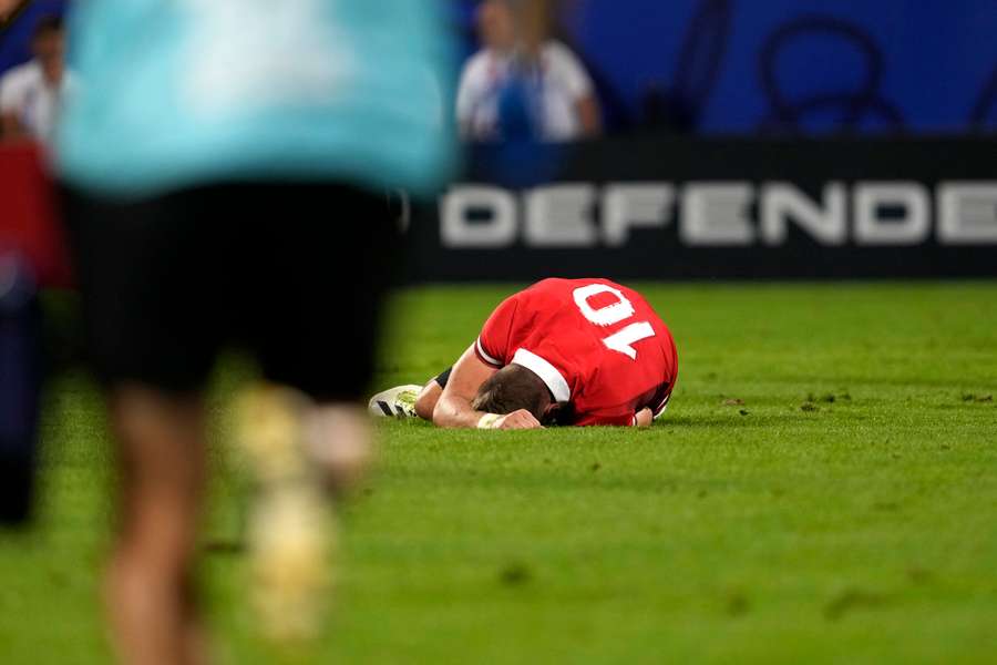 Biggar lies injured on the field