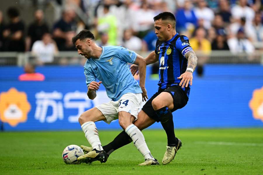 Inter Milan's Argentine forward Lautaro Martinez (right) fights for the ball with Lazio's Spanish defender Mario Gila Fuentes