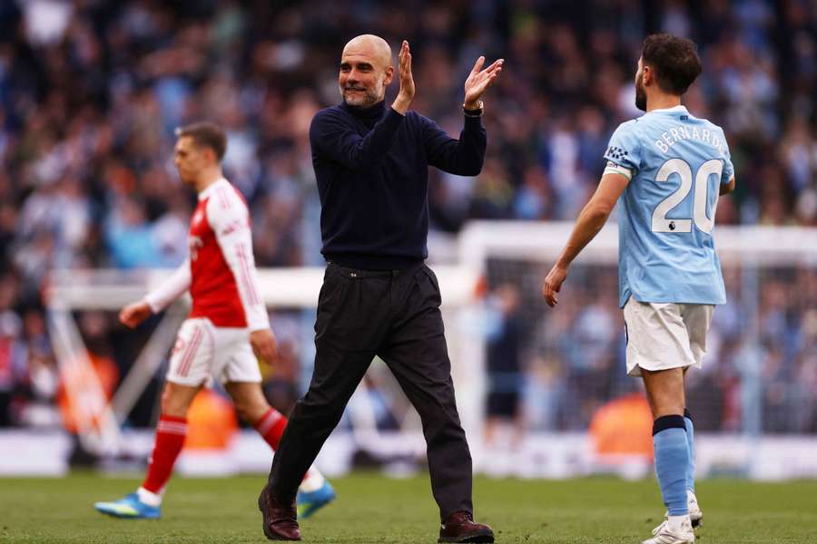Pep Guardiola applauds fans after the game