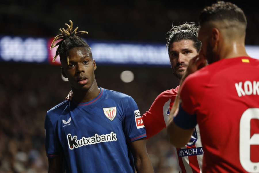 Athletic Bilbao's Nico Williams reacts with Atletico Madrid's Rodrigo De Paul and Koke after receiving racist abuse from the crowd 