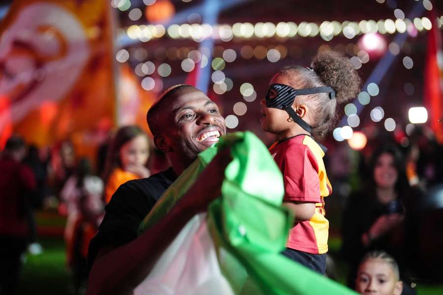 Osimhen celebrates after the match with his daughter