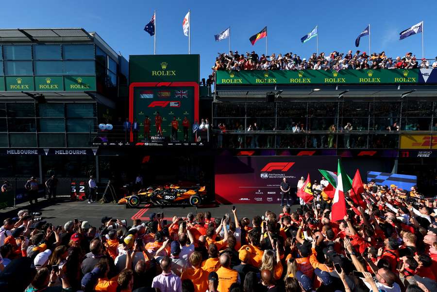 Ferrari's Carlos Sainz celebrates on the podium after winning the Australian Grand Prix in 2024