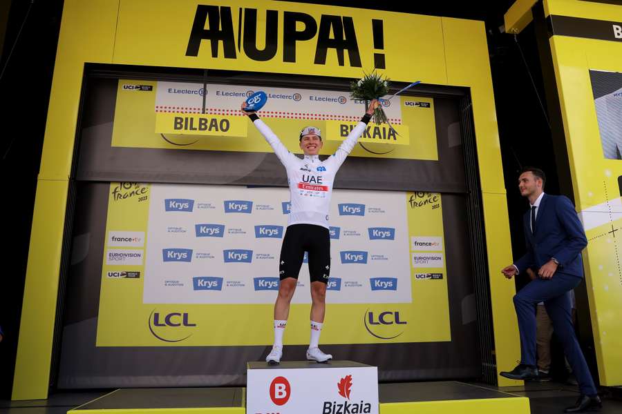 UAE Team Emirates' Tadej Pogacar celebrates on the podium with the best young rider's white jersey