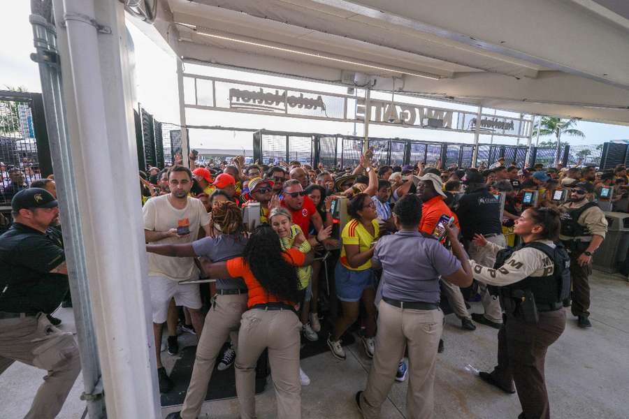 Fans rush the gates before the match between Argentina and Colombia 