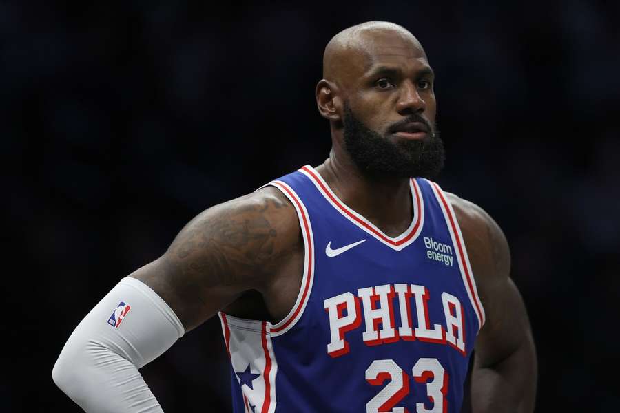 Philadelphia 76ers' LeBron James stands on the court during the first half of a preseason game