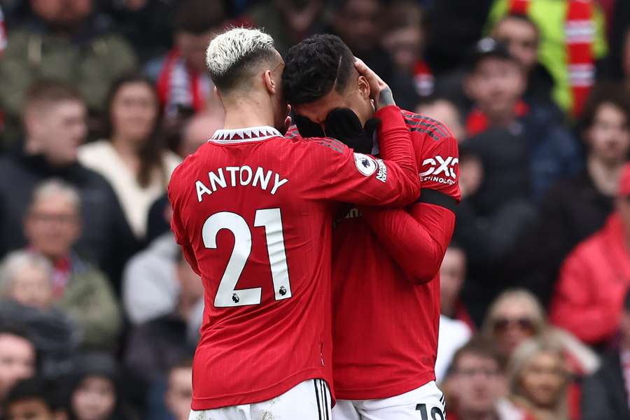 Manchester United's Brazilian midfielder Casemiro is consoled by Manchester United's teammate Antony