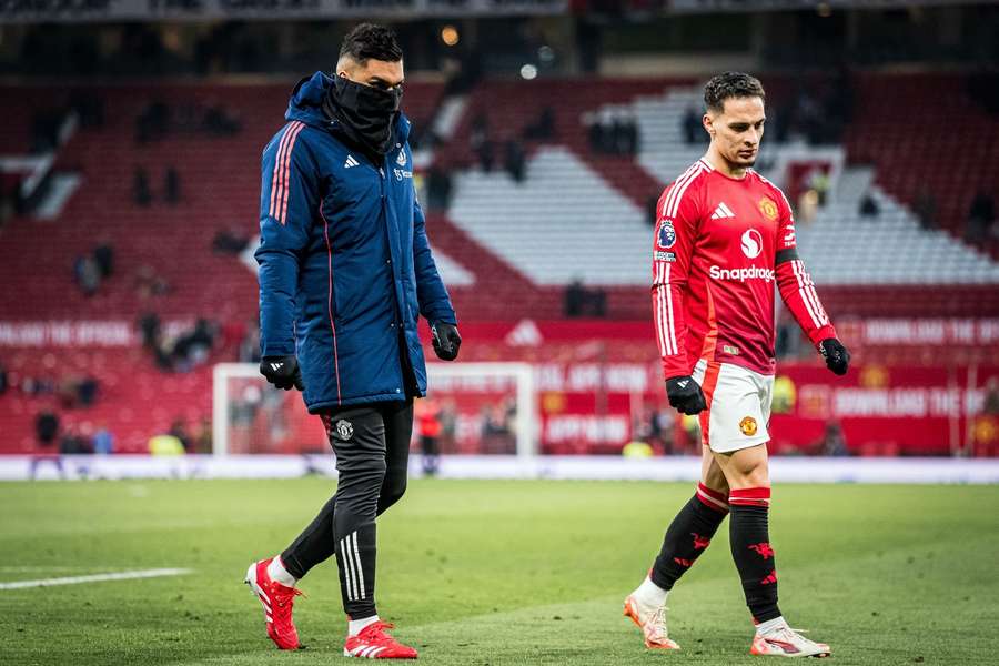 Manchester United's Antony and Casemiro leave the pitch disappointed after losing 1-3 against Brighton