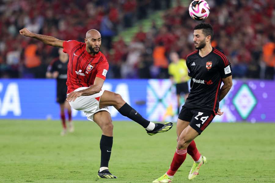 Urawa Red Diamonds' Jose Kante in action with Al Ahly's Mohamed Abdelmonem
