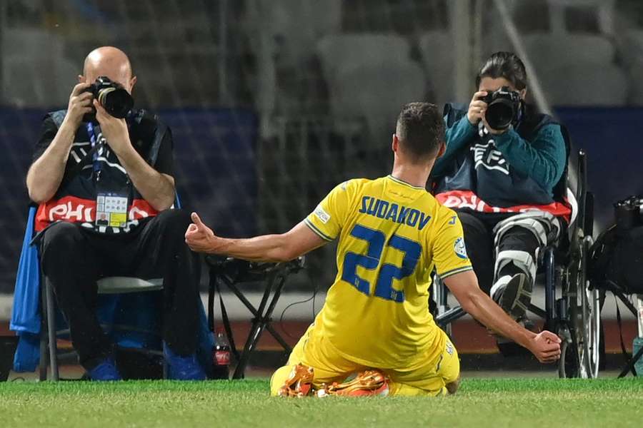 Georgiy Sudakov knee slides in celebration after scoring for Ukraine