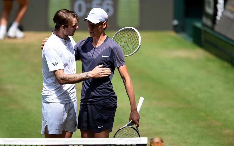 Alexander Bublik (L) reacts after Jannik Sinner withdraws through injury