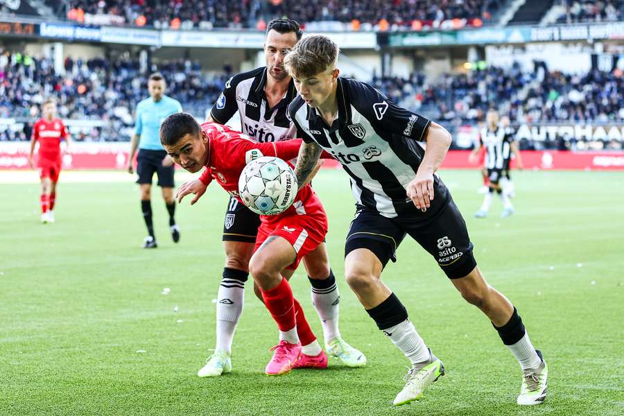 Een speler van Heracles en FC Twente in duel Een speler van Heracles en FC Twente in duel