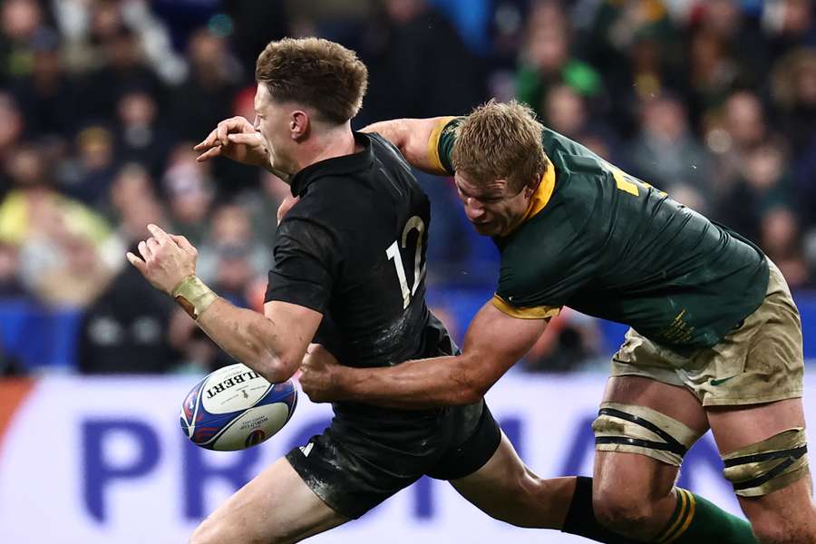 New Zealand's inside centre Jordie Barrett (L) is tackled by South Africa's flanker Pieter-Steph du Toit (R)