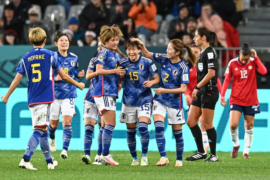 Japan midfielder Fujino (C) celebrates scoring her team's second goal