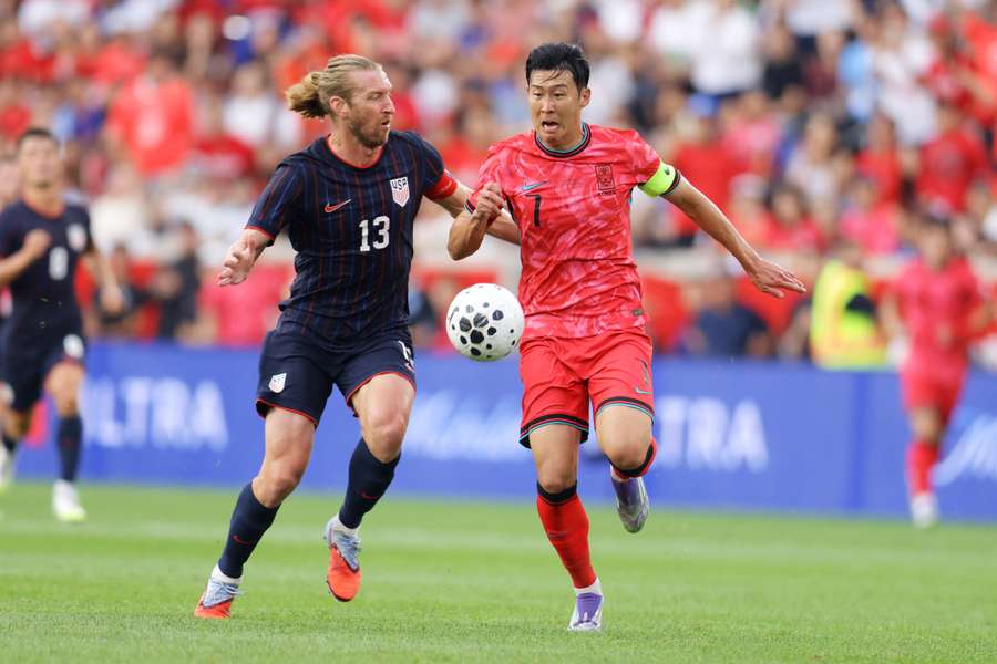 Son Heung-min of South Korea and Tim Ream of the United States vie for the ball