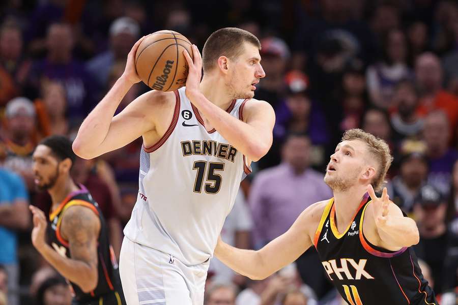 Nikola Jokic of the Denver Nuggets handles the ball against Jock Landale of the Phoenix Suns