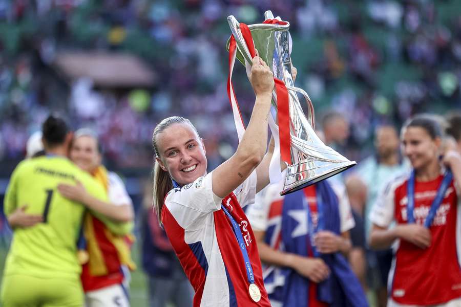 Arsenal's Beth Mead holds the Champions League trophy aloft after beating Barcelona in the 2025 final