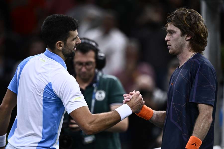 Novak Djokovic shakes hands with Andrey Rublev at the end of the match