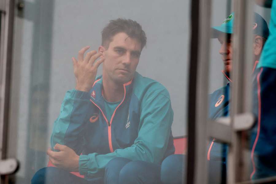 Australia's captain Pat Cummings reacts as rain delays start of day five