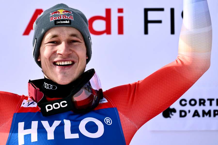 First-placed Swiss Marco Odermatt celebrates on the podium after the men's Super-G of the FIS Alpine Ski World Cup