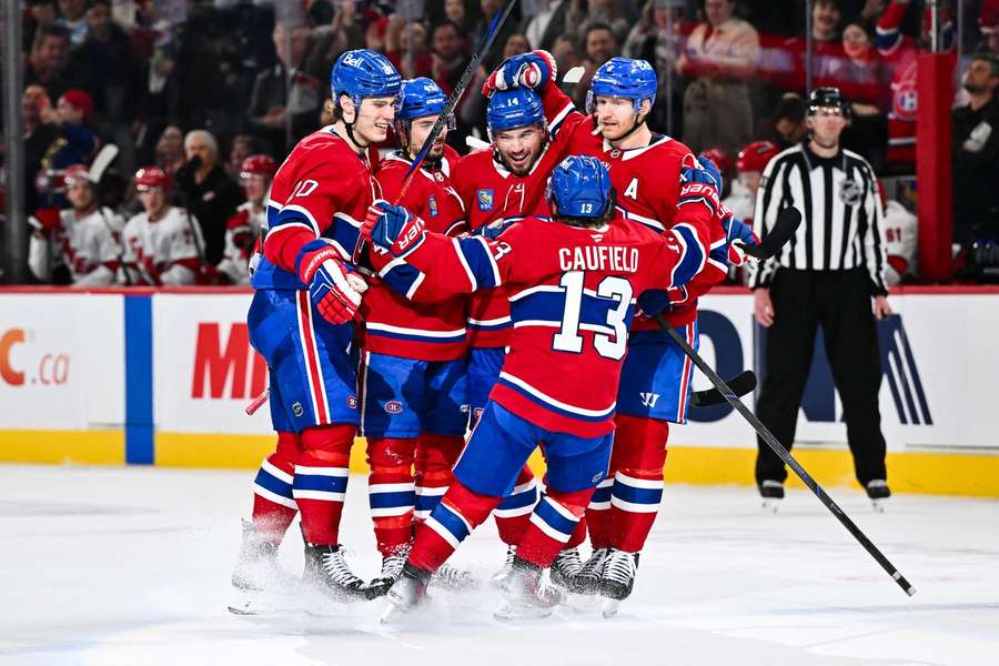 Nick Suzuki of the Montreal Canadiens celebrates his goal with teammates