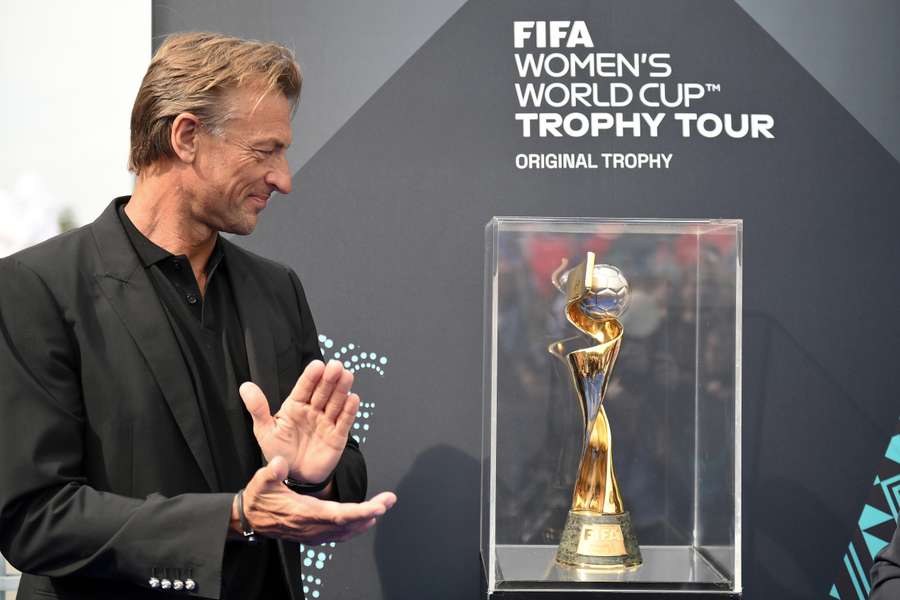 French national women's football team head coach Herve Renard looks at the FIFA Women's World Cup trophy in Paris