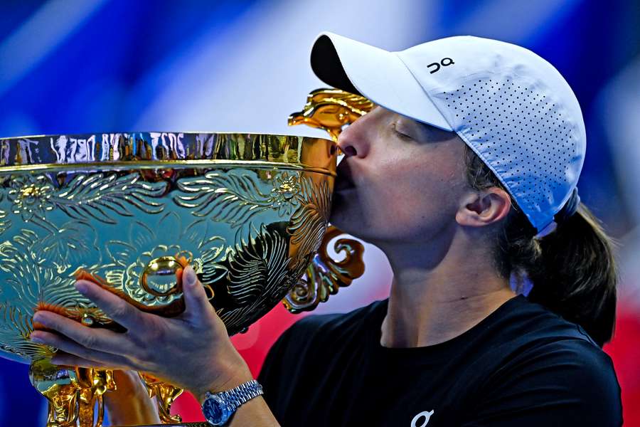 Poland's Iga Swiatek kisses the winning trophy after defeating Russia's Liudmila Samsonova in the women's singles final match of the WTA China Open 