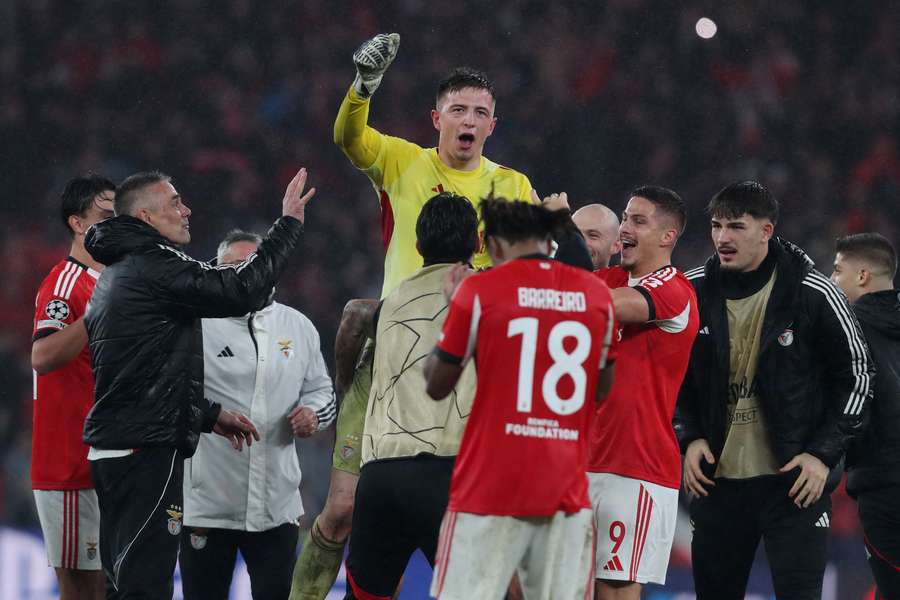 Benfica celebrate progressing to the knockout rounds of the Champions League.