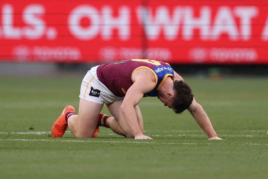 Lachie Neale keels over in discomfort during the preliminary final win against Hawthorn. Lachie Neale keels over in discomfort during the preliminary final win against Hawthorn.