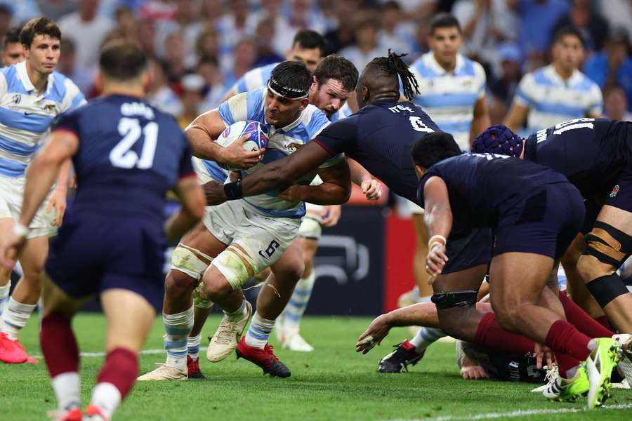 Argentina's blindside flanker Pablo Matera is tackled by England lock Maro Itoje