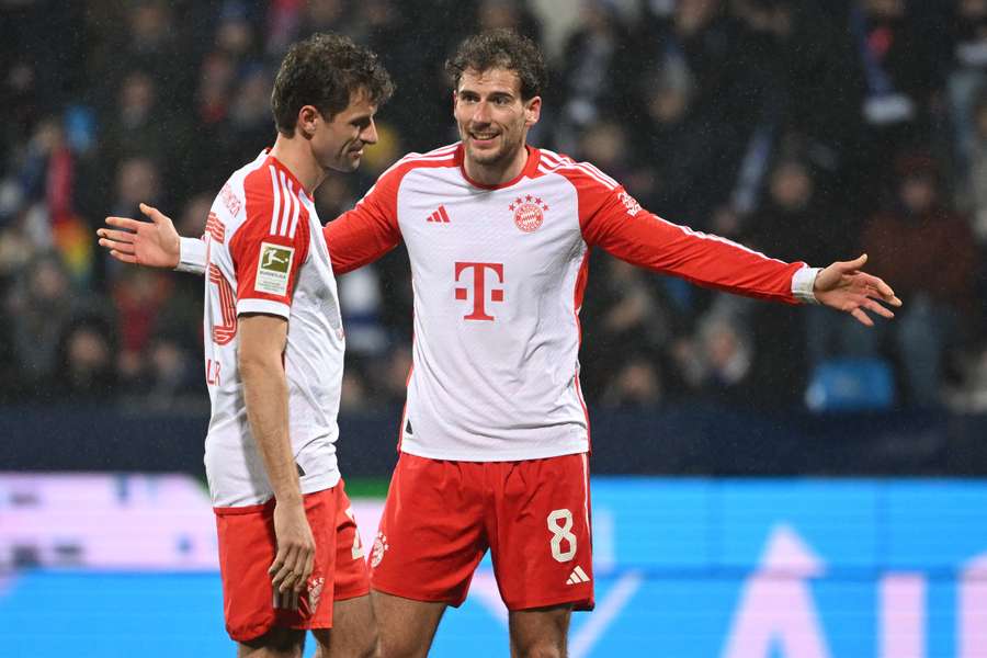 Bayern Munich's Leon Goretzka (R) and Thomas Muller react