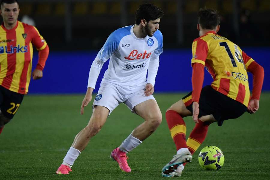 Napoli's Georgian forward Khvicha Kvaratskhelia fights for the ball with Lecce's Icelandic midfielder Thorir Johann Helgason