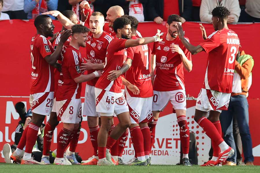 Brest's players celebrate after scoring against Monaco
