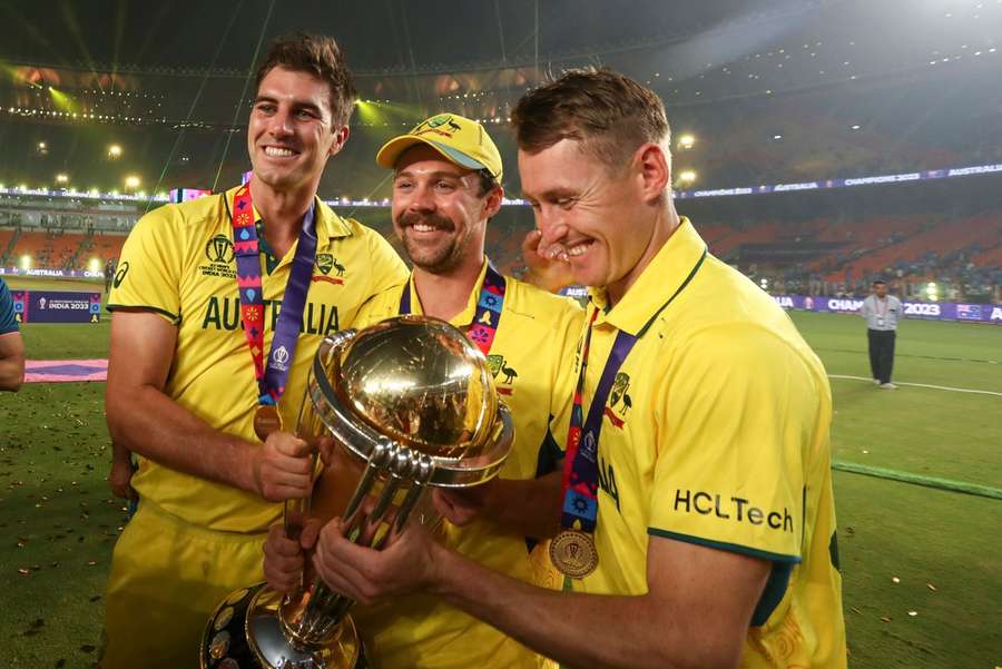 Australia's (left-to-right) Pat Cummins, Travis Head and Marnus Labuschagne pose with the trophy after winning the Cricket World Cup final