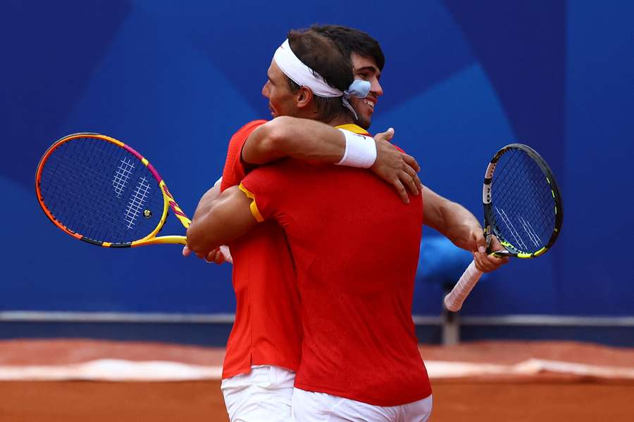 Carlos Alcaraz and Rafael Nadal of Spain celebrate after winning the match