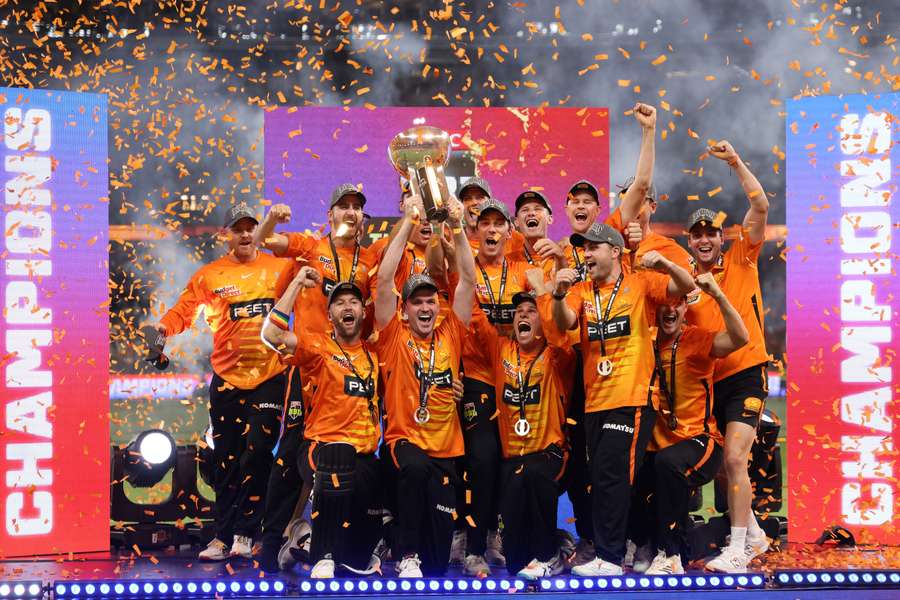 Perth Scorchers players celebrate with the trophy after winning the Big Bash League final against Brisbane Heat