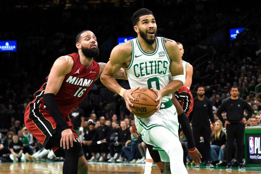 Boston Celtics forward Jayson Tatum drives to the basket past Miami Heat forward Caleb Martin