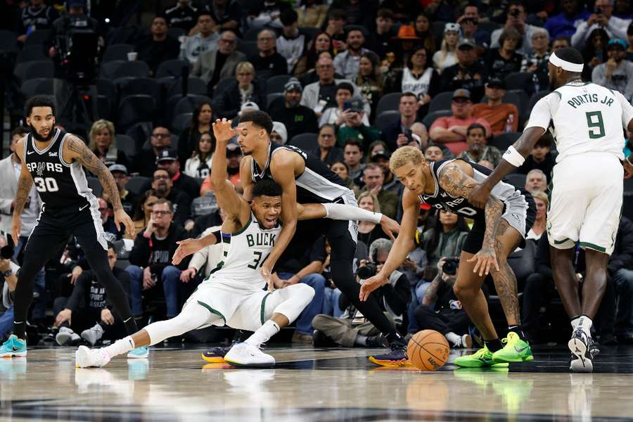 Milwaukee Bucks' Giannis Antetokounmpo loses control of the ball as he drives on Victor Wembanyama of the San Antonio Spurs