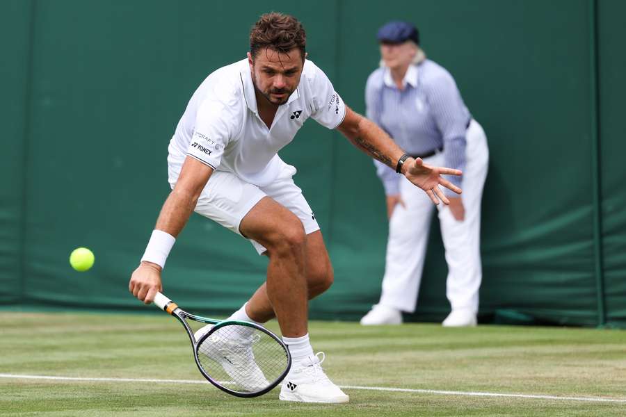 Stan Wawrinka returns the ball to Tomas Martin Etcheverry during their second round clash at Wimbledon