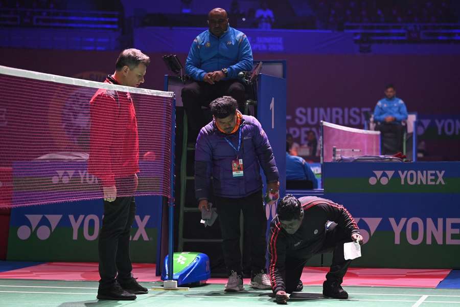 Officials seen cleaning the bird droppings during Men's Single match between Indian shuttler HS Prannoy and Loh Kean Yew from Singapore Officials seen cleaning the bird droppings during Men's Single match between Indian shuttler HS Prannoy and Loh Kean Yew from Singapore