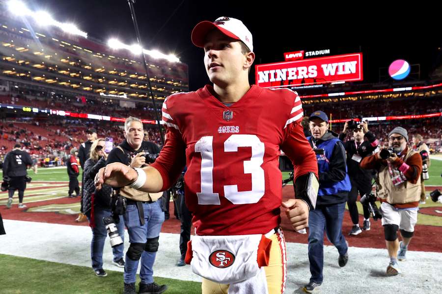 San Francisco quarterback Brock Purdy runs off the field after the 49ers' victory over the Dallas Cowboys