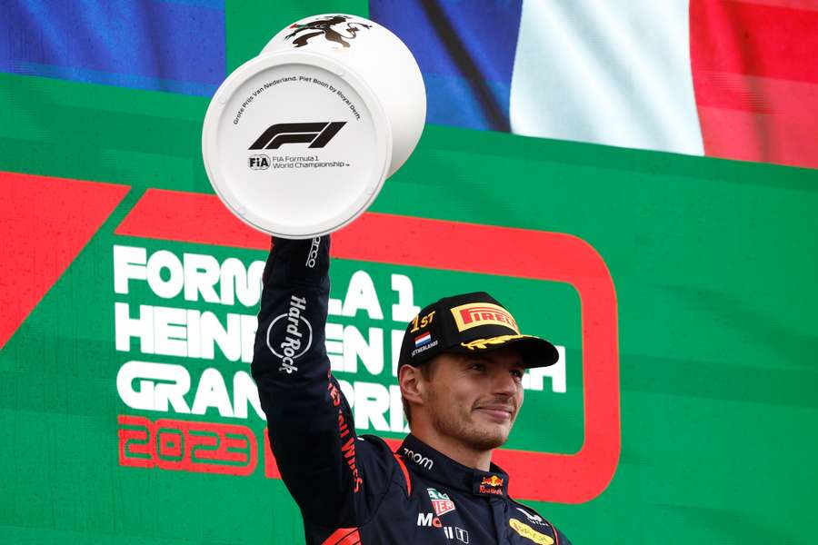 Red Bull's Max Verstappen celebrates with the trophy on the podium