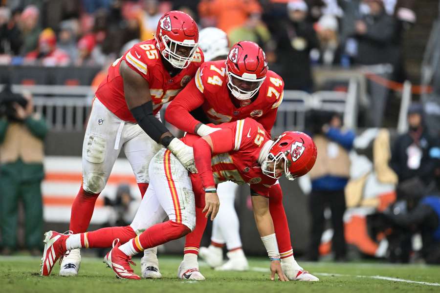 Patrick Mahomes is helped up by his offensive lineman after taking a shot during Sunday's game against the Cleveland Browns