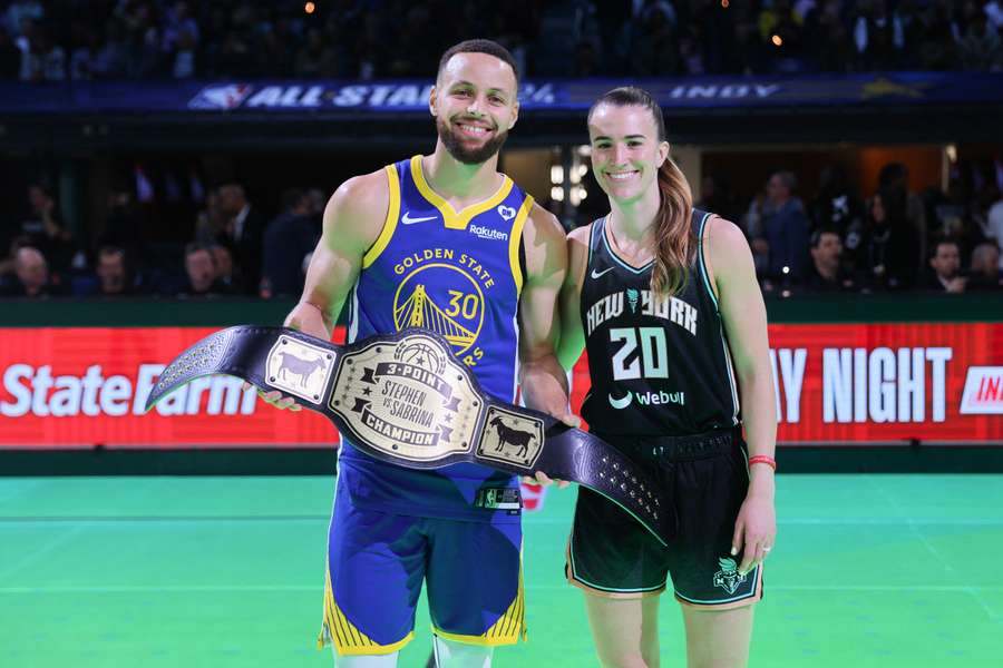 Stephen Curry of the Golden State Warriors and Sabrina Ionescu of the New York Liberty pose for a photo after their 3-point challenge